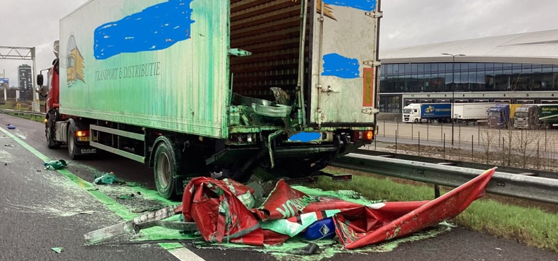 Vrachtwagen staat stil op A58, een achterklep ligt op straat omringd door groene vloeistof